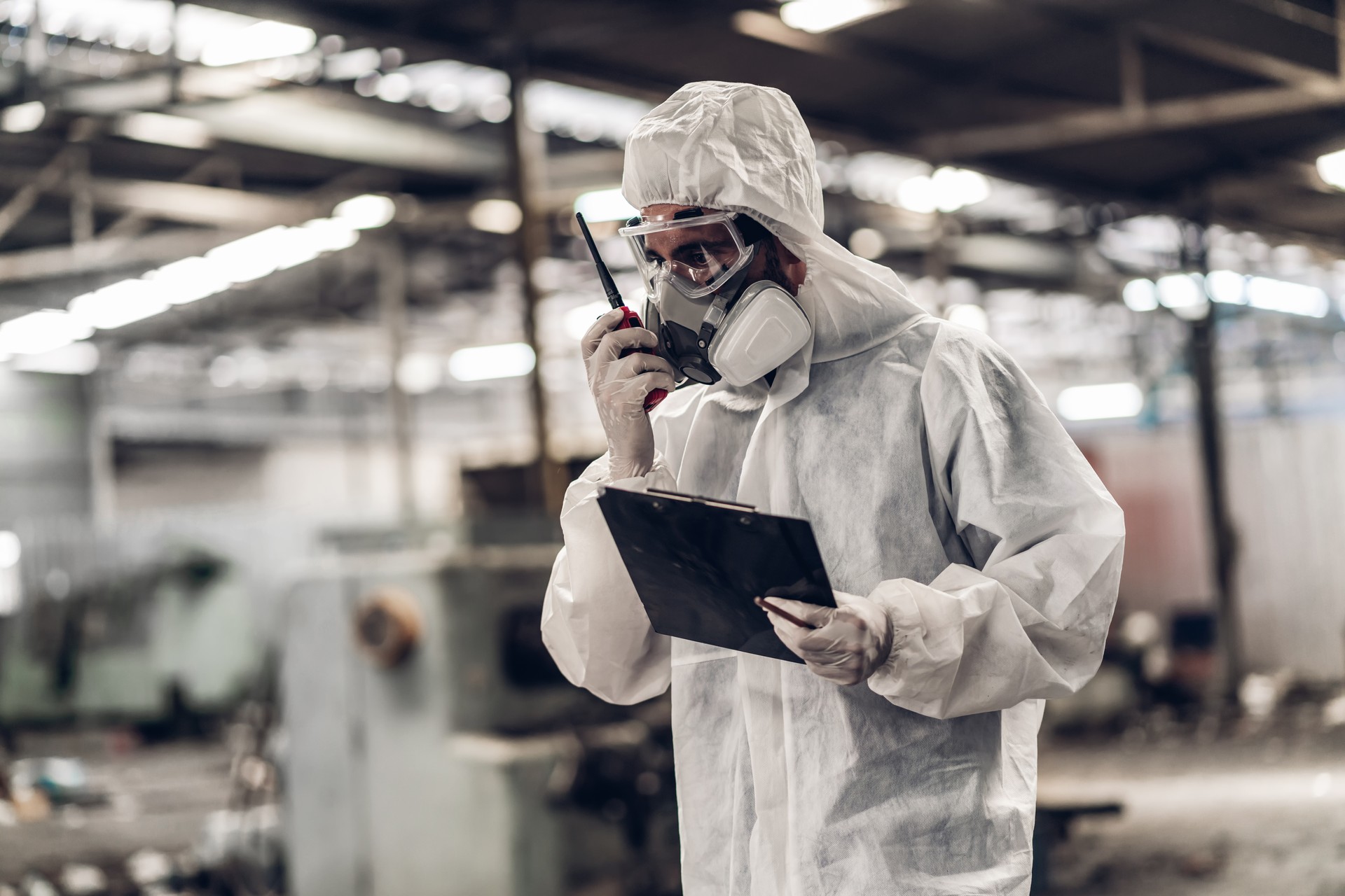 Scientist wear Chemical protection suit check danger chemical, working at dangerous zone in Red and White Lines of barrier tape. Red and white Hazardous restricted area factory safety worker industry